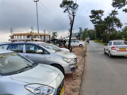 Happy Yatra Travels taxis parked on a Meghalaya hill road